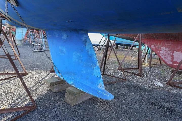 Slide: The Image of Blue keel of a 1991 Beneteau First 310 sailboat on stands. - 5