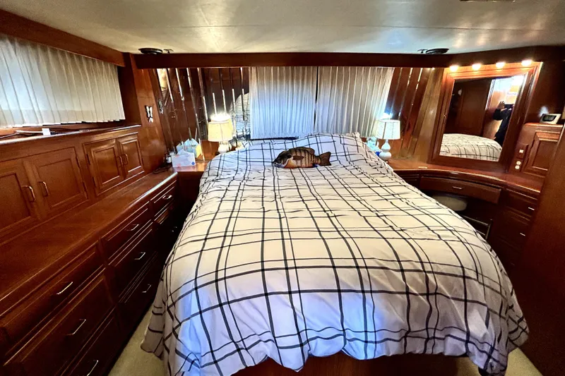 Slide: The Image of Luxurious cabin interior of 1989 Ocean Alexander 44 CPMY with wood paneling and cozy bedding. - 11