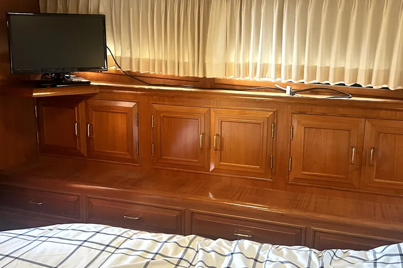 Slide: The Image of Interior of 1989 Ocean Alexander 44 CPMY with wood cabinetry and mounted TV. - 12