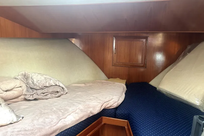 Slide: The Image of Cozy cabin interior of 1989 Ocean Alexander 44 CPMY with wooden paneling and twin beds. - 21