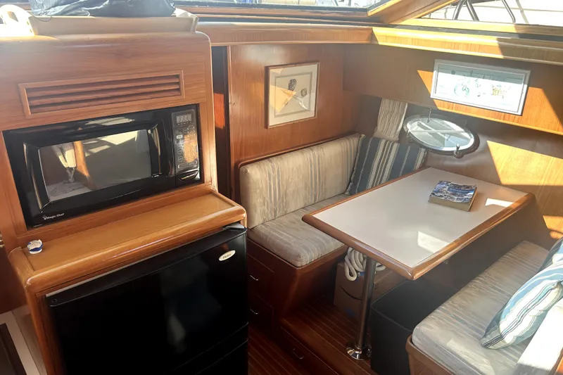 Slide: The Image of Cozy dining area in 1989 Ocean Alexander 44 CPMY yacht with microwave and fridge. - 25