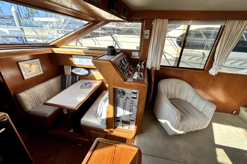 Slide: The Image of 1989 Ocean Alexander 44 CPMY yacht interior with helm, seating, and dining area. - 26