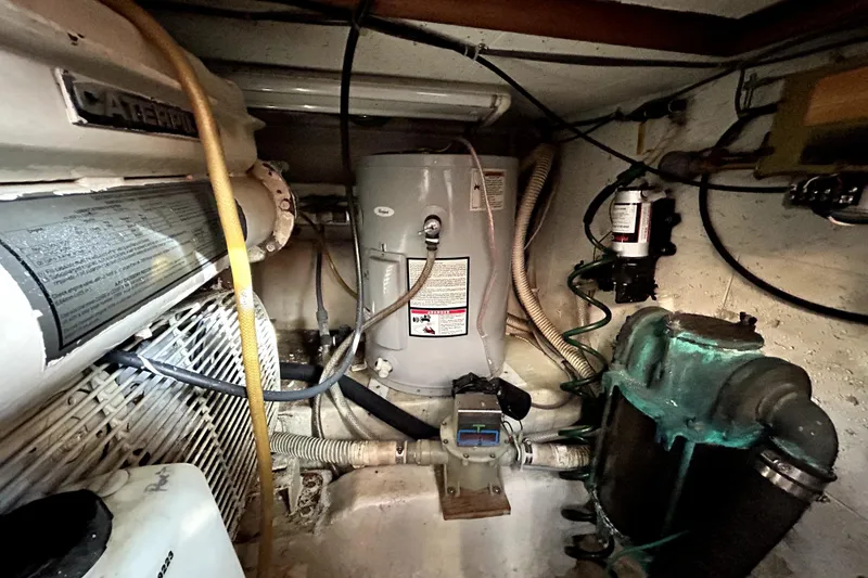 Slide: The Image of Engine room of 1989 Ocean Alexander 44 CPMY with Caterpillar components and plumbing. - 29