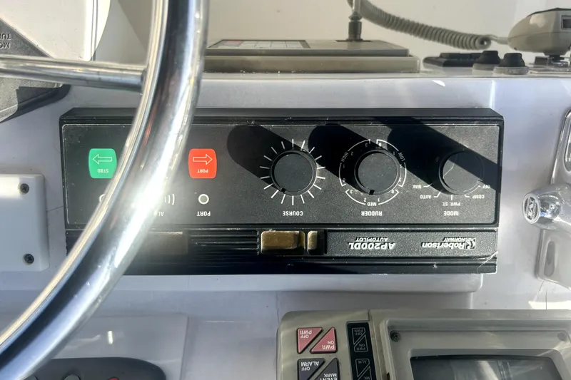 Slide: The Image of Control panel of 1989 Ocean Alexander 44 CPMY yacht with steering wheel and navigation controls. - 36