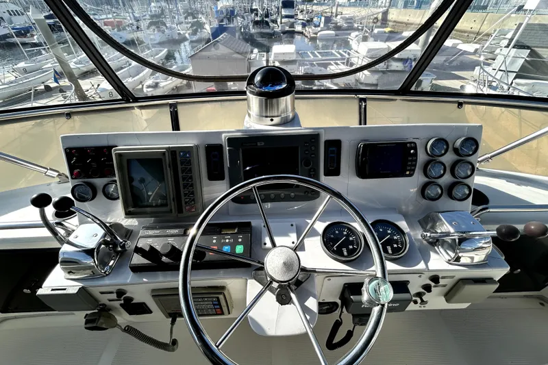 Slide: The Image of Cockpit of 1989 Ocean Alexander 44 CPMY yacht with steering wheel and navigation instruments. - 4