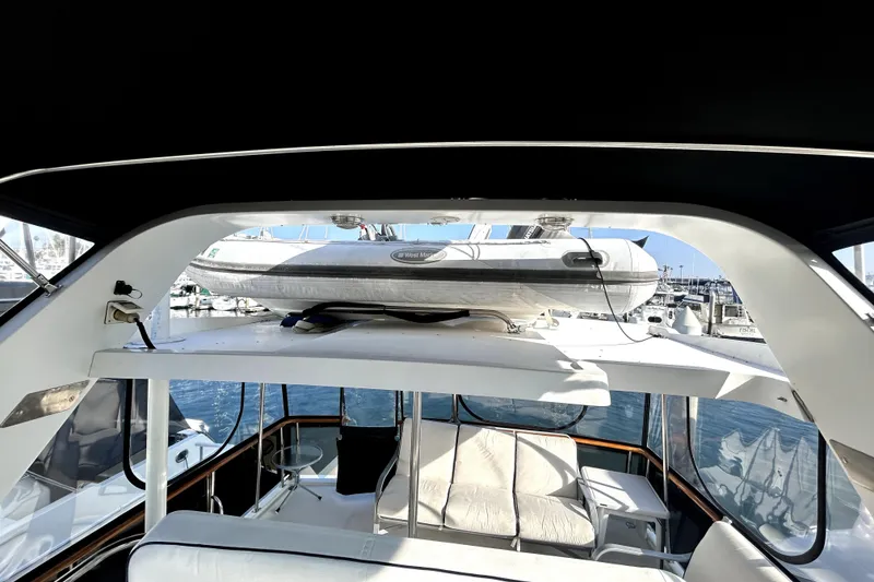 Slide: The Image of 1989 Ocean Alexander 44 CPMY yacht interior with inflatable boat on deck, docked at marina. - 7