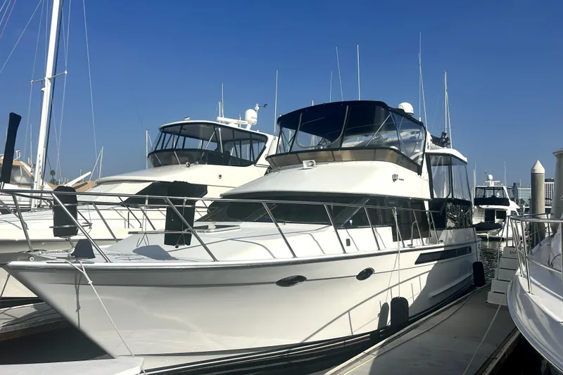 The Image of 1989 Ocean Alexander 44 CPMY yacht docked at marina under clear blue sky. - 0