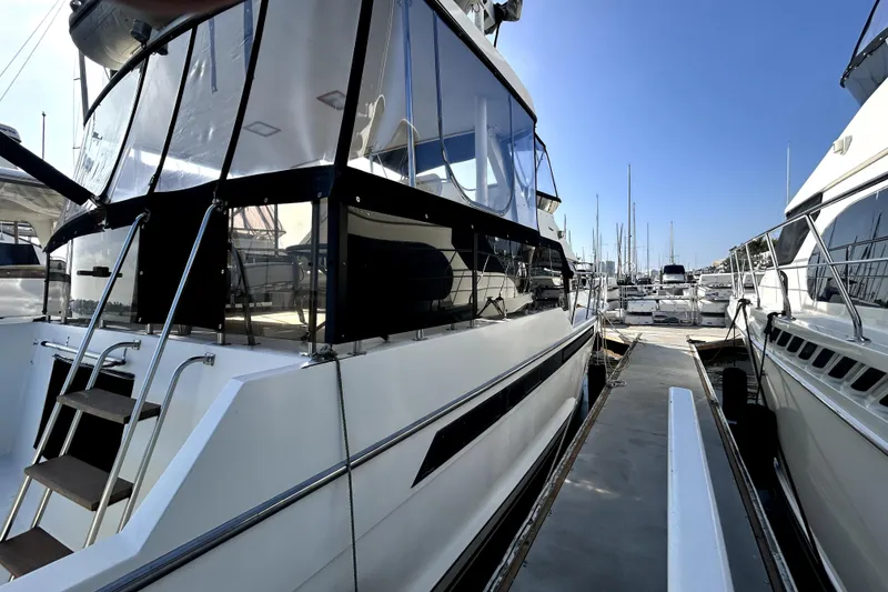 Slide: The Image of 1989 Ocean Alexander 44 CPMY yacht docked at marina, side view with clear skies. - 1