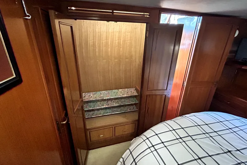 Slide: The Image of 1989 Ocean Alexander 44 CPMY cabin with wooden closet and bed. - 13