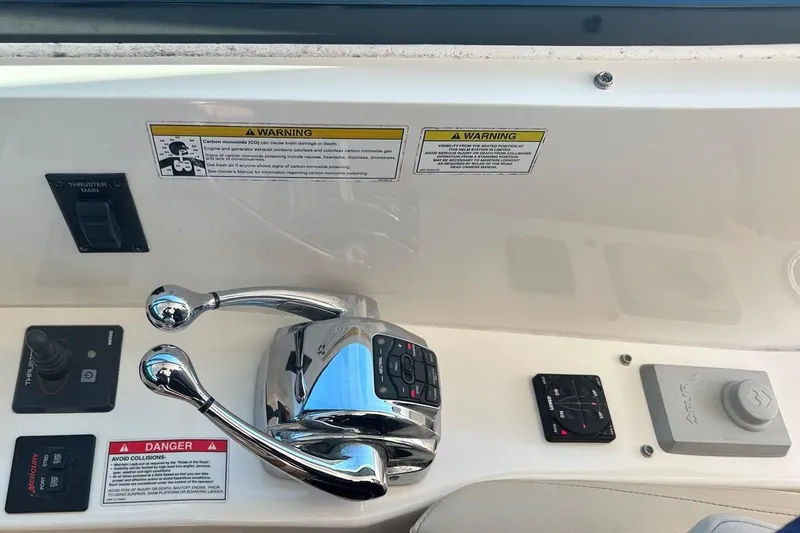 Slide: The Image of Control panel of a 2014 Sea Ray 410 Sundancer boat with warning labels. - 18