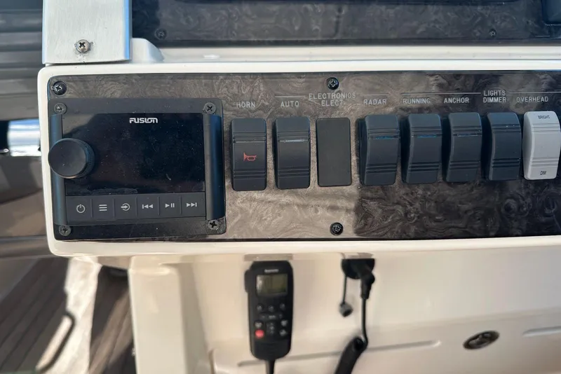 Slide: The Image of Control panel of 2014 Sea Ray 410 Sundancer with Fusion audio system and switches. - 19