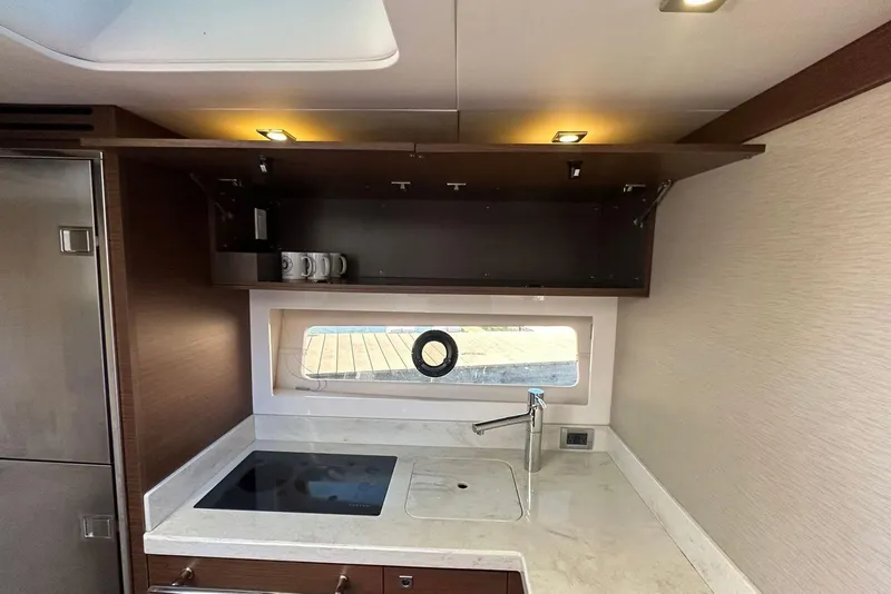 Slide: The Image of Modern kitchen area in 2014 Sea Ray 410 Sundancer yacht with sleek cabinetry. - 23