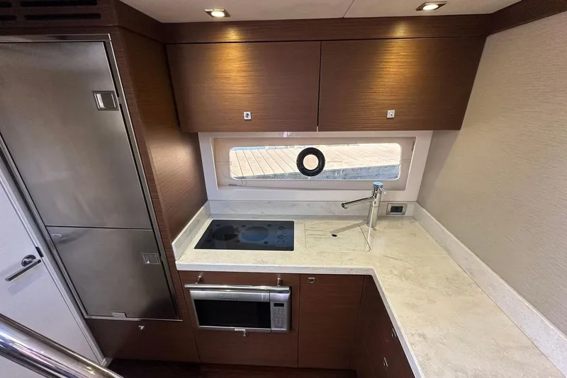 Slide: The Image of Luxurious 2014 Sea Ray 410 Sundancer yacht kitchen with modern appliances and sleek design. - 26