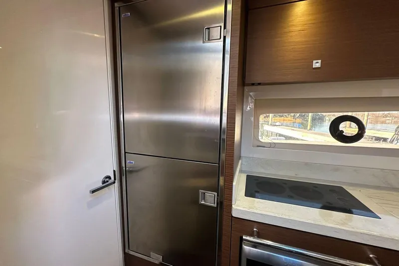 Slide: The Image of Modern kitchen area in 2014 Sea Ray 410 Sundancer yacht with stainless steel appliances. - 27