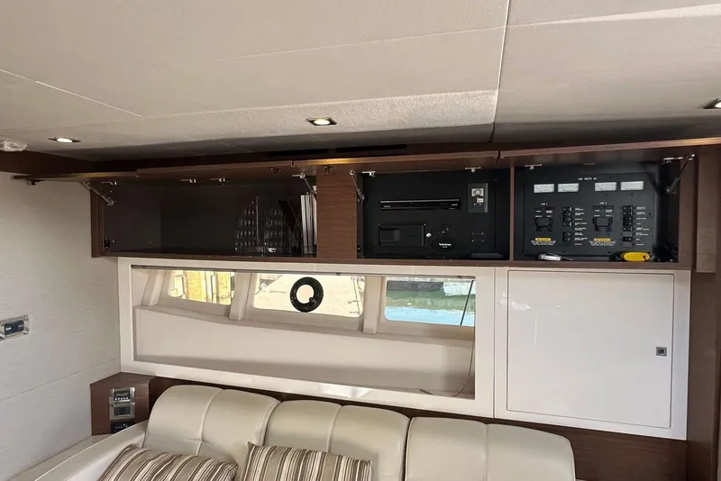 Slide: The Image of Interior of 2014 Sea Ray 410 Sundancer yacht with control panels and seating area. - 31