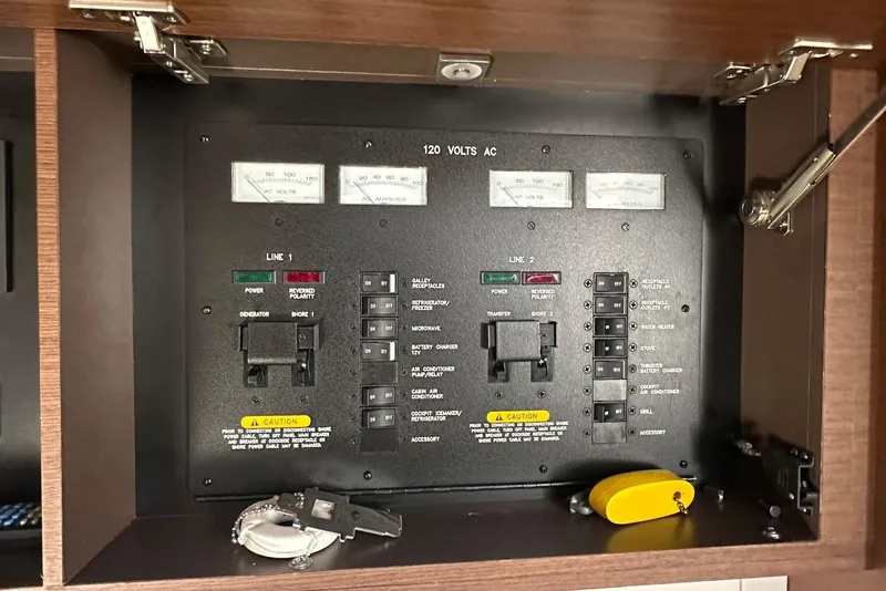 Slide: The Image of Electrical panel of a 2014 Sea Ray 410 Sundancer boat, featuring switches and meters. - 33