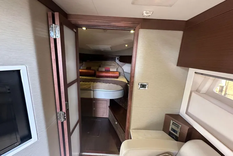 Slide: The Image of Interior of 2014 Sea Ray 410 Sundancer yacht, featuring cozy bedroom and modern design. - 37