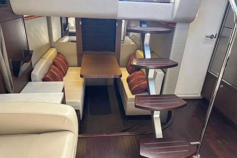 Slide: The Image of Interior of 2014 Sea Ray 410 Sundancer yacht with modern seating and wooden steps. - 46