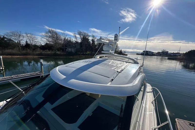 Slide: The Image of 2014 Sea Ray 410 Sundancer yacht docked on a sunny day, reflecting on calm water. - 54