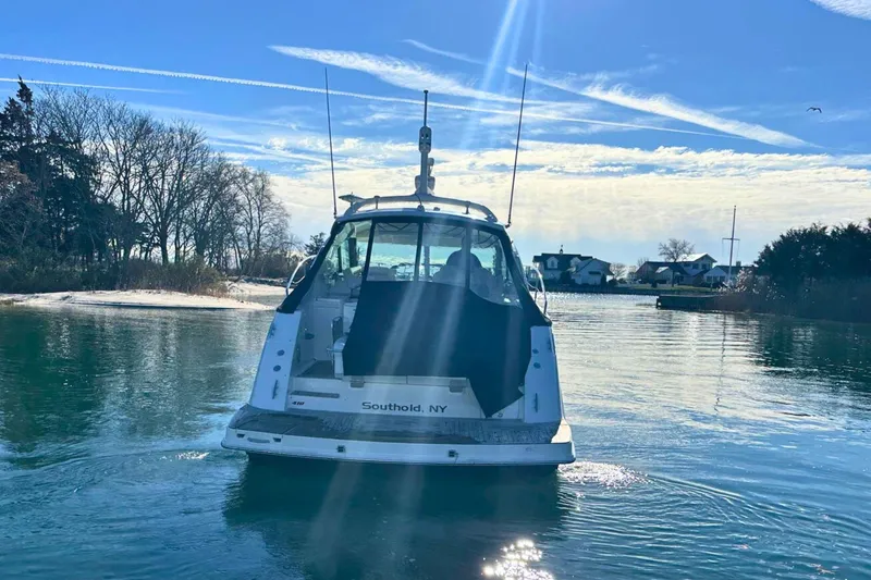 Slide: The Image of 2014 Sea Ray 410 Sundancer yacht on calm water near Southold, NY. - 7