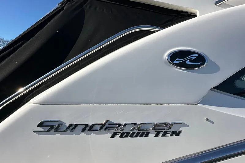Slide: The Image of 2014 Sea Ray 410 Sundancer boat with sleek design and logo detail. - 8