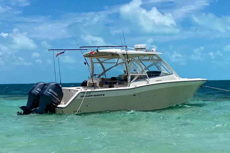 The Image of 2013 Grady-White Freedom 335 boat anchored in clear turquoise water. - 0