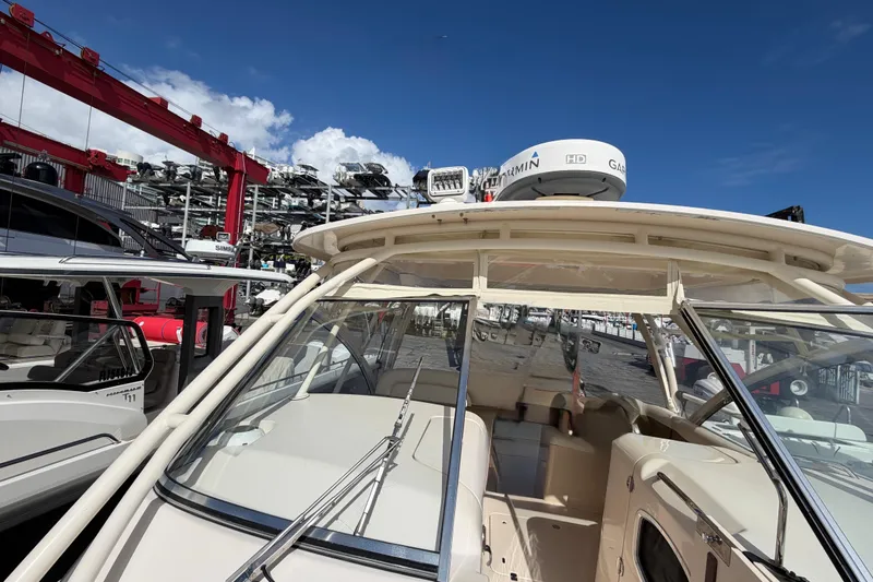 Slide: The Image of 2013 Grady-White Freedom 335 boat interior with spacious seating in a marina setting. - 104