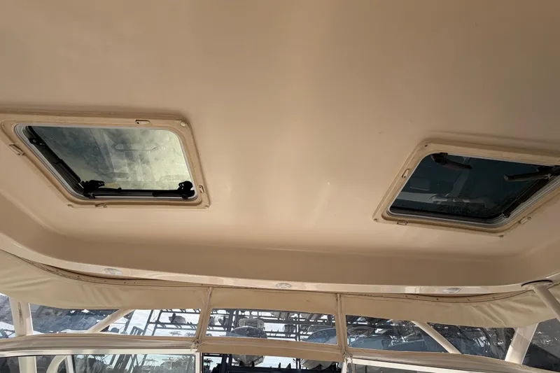 Slide: The Image of Engine compartment of 2013 Grady-White Freedom 335 boat, showing batteries and generator. - 114