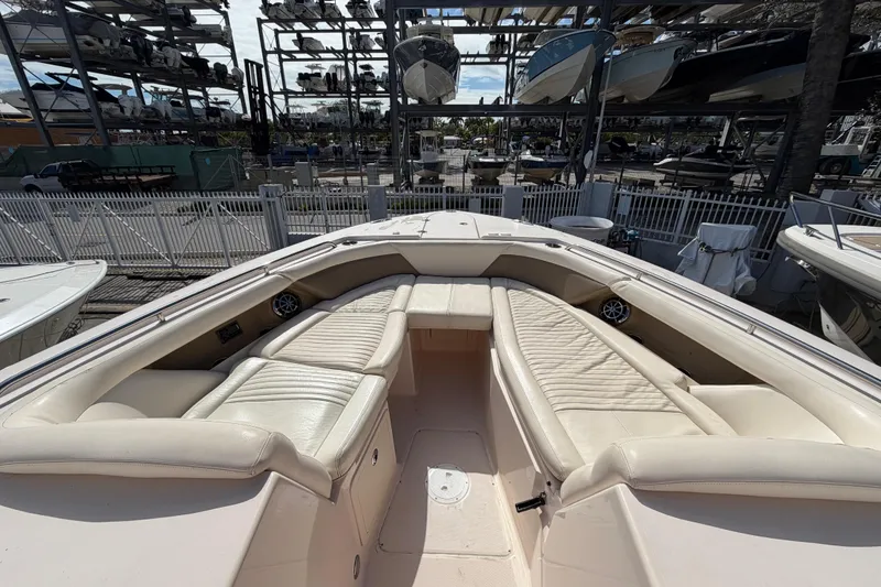 Slide: The Image of 2013 Grady-White Freedom 335 boat interior with white seating and dual engines. - 115