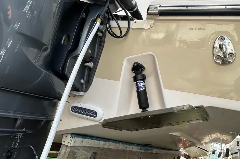 Slide: The Image of 2013 Grady-White Freedom 335 boat in a marina, surrounded by other vessels and equipment. - 12