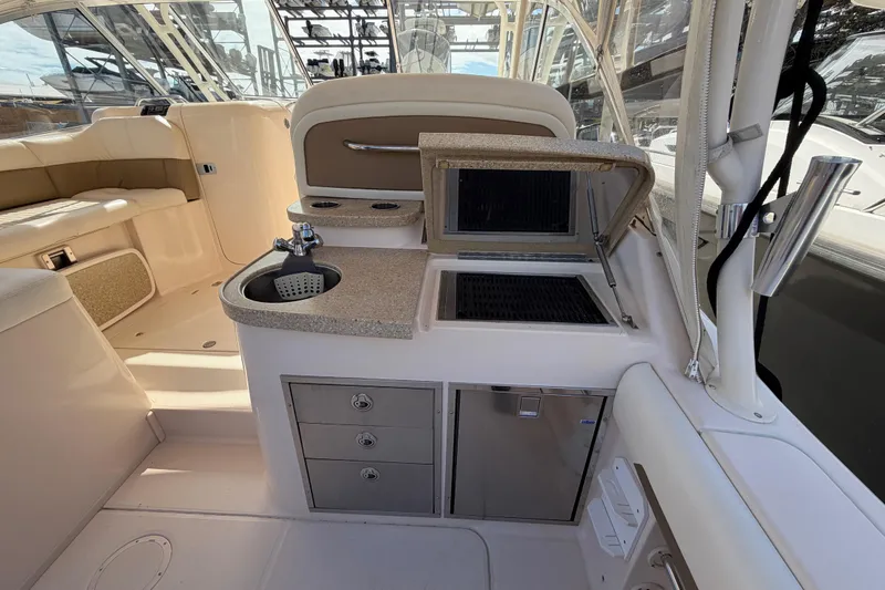 Slide: The Image of 2013 Grady-White Freedom 335 boat, rear view with cover, on dry dock. - 130