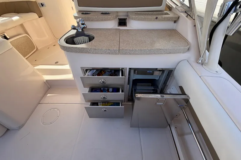 Slide: The Image of 2013 Grady-White Freedom 335 boat in storage, sunlit hull detail. - 131