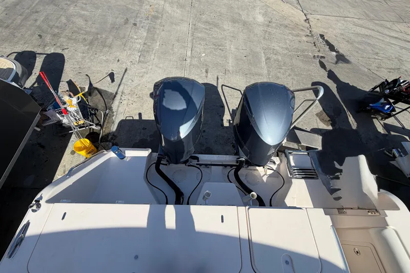 Slide: The Image of 2013 Grady-White Freedom 335 boat hull with fender, docked under clear sky. - 136