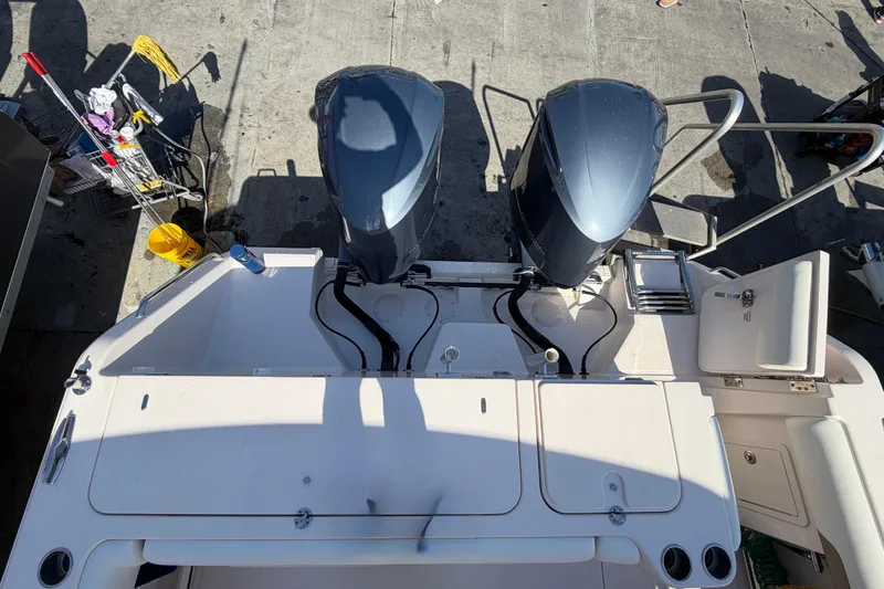 Slide: The Image of 2013 Grady-White Freedom 335 boat hull on dry dock, supported by wooden blocks. - 138