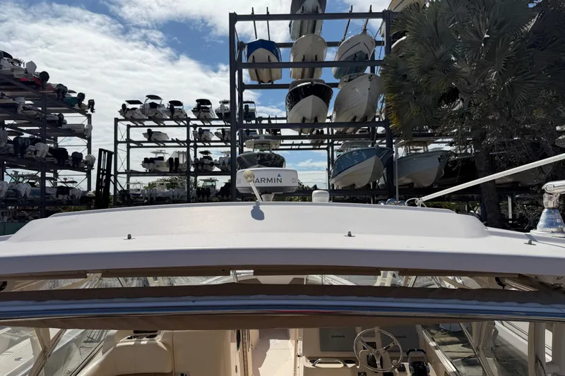 Slide: The Image of 2013 Grady-White Freedom 335 boat side view at a marina. - 140