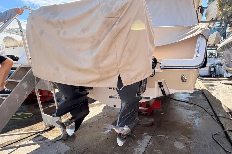 Slide: The Image of 2013 Grady-White Freedom 335 boat, docked, viewed from the front under a clear blue sky. - 141