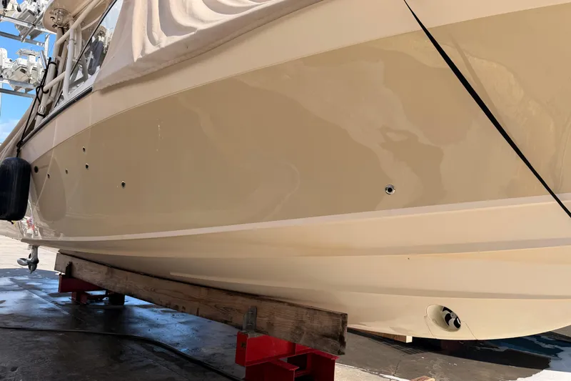 Slide: The Image of 2013 Grady-White Freedom 335 boat on dry dock, side view. - 142