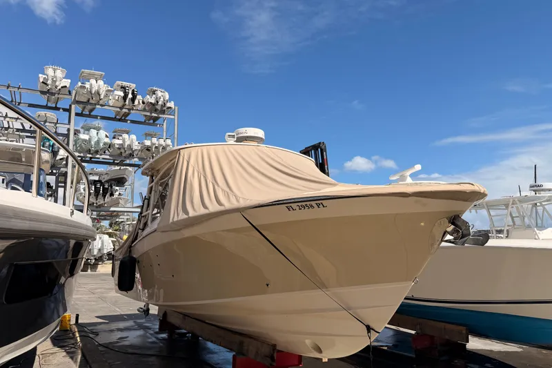 Slide: The Image of 2013 Grady-White Freedom 335 boat docked under clear blue sky. - 145