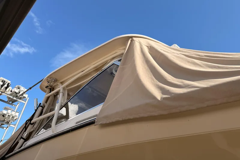 Slide: The Image of 2013 Grady-White Freedom 335 boat on lift, showcasing hull and exterior details. - 149