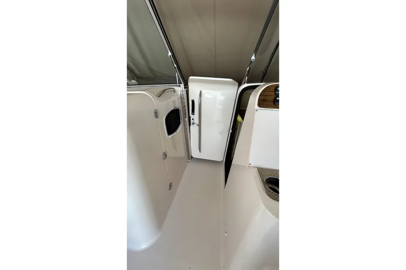 Slide: The Image of Control panel of 2013 Grady-White Freedom 335 boat with steering wheel and navigation screens. - 24