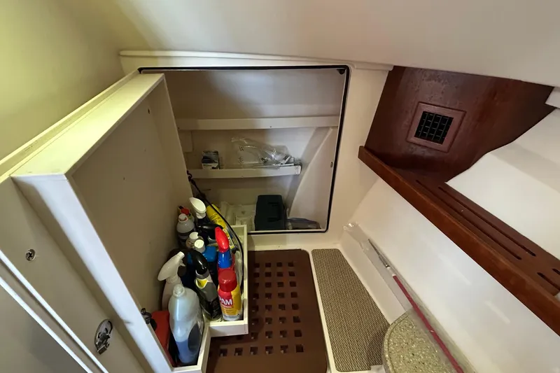 Slide: The Image of Interior storage area of 2013 Grady-White Freedom 335 boat with cleaning supplies. - 29