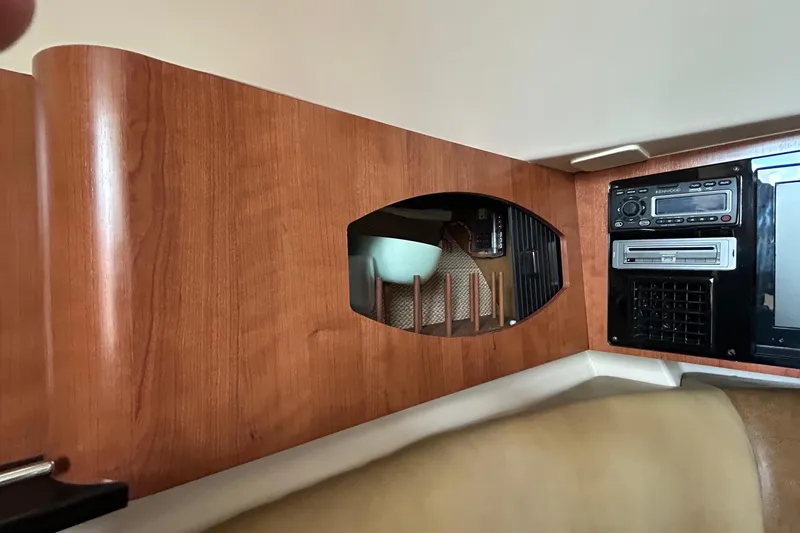 Slide: The Image of 2013 Grady-White Freedom 335 interior storage compartment with open wooden door. - 33