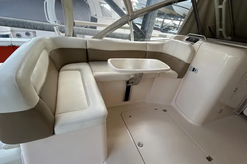 Slide: The Image of 2013 Grady-White Freedom 335 boat interior with cushioned seating and table. - 42