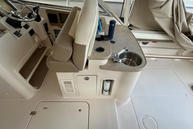 Slide: The Image of 2013 Grady-White Freedom 335 boat interior with seating and storage compartments. - 49