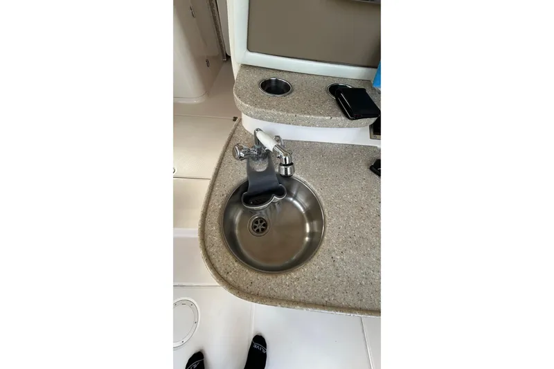 Slide: The Image of 2013 Grady-White Freedom 335 boat dashboard with controls and communication device. - 54