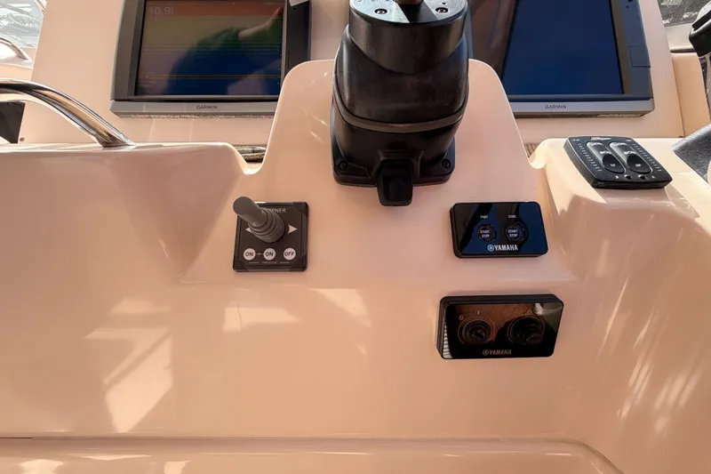 Slide: The Image of 2013 Grady-White Freedom 335 boat interior with seating, sink, and helm station. - 67