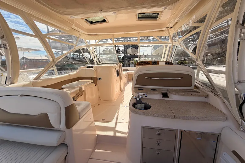 Slide: The Image of 2013 Grady-White Freedom 335 boat dashboard with Garmin navigation systems and controls. - 77
