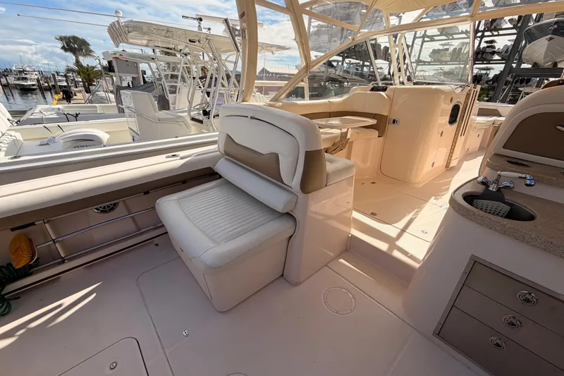 Slide: The Image of 2013 Grady-White Freedom 335 boat interior with beige seating and table. - 78
