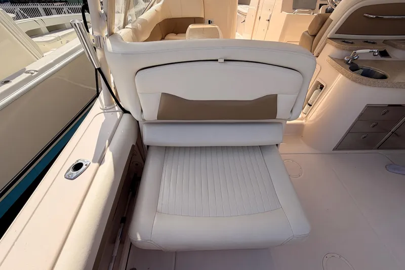 Slide: The Image of 2013 Grady-White Freedom 335 boat interior with seating and storage compartments. - 79