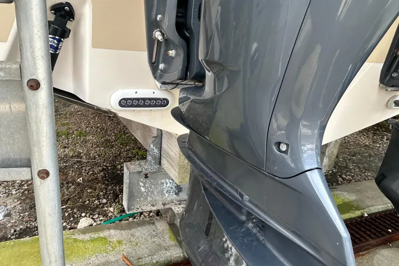 Slide: The Image of 2013 Grady-White Freedom 335 boat with beige cover, docked under a clear blue sky. - 8